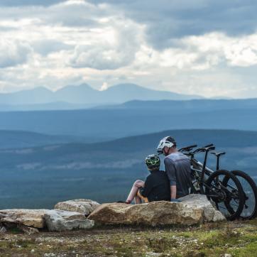 Father and son on mountain with bicycles.