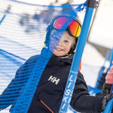 A kid in the ski slopes.