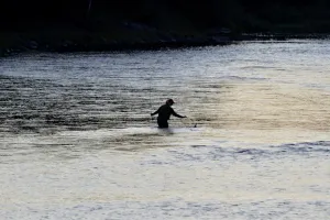 A fisherman in a river.