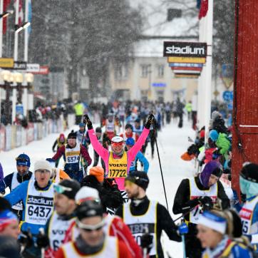 Cross country skiers cross the finish line.
