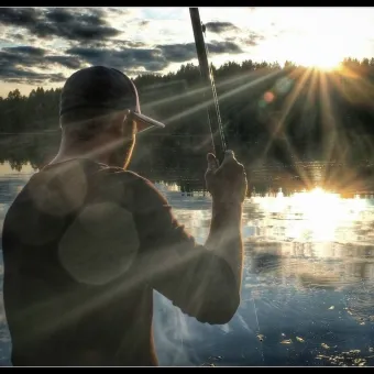 Guy fishing in the lake.