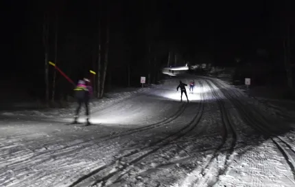 Skiers in the dark.