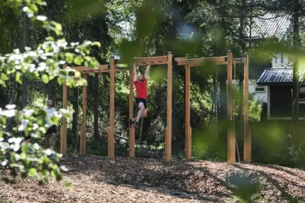 A man climbs into a climbing frame.
