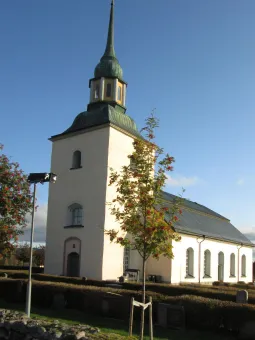 White church with dark tower and roof.