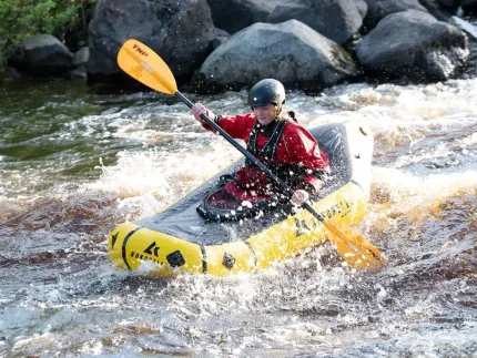 A person packrafting in a river.
