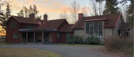 A house with a driveway and trees.