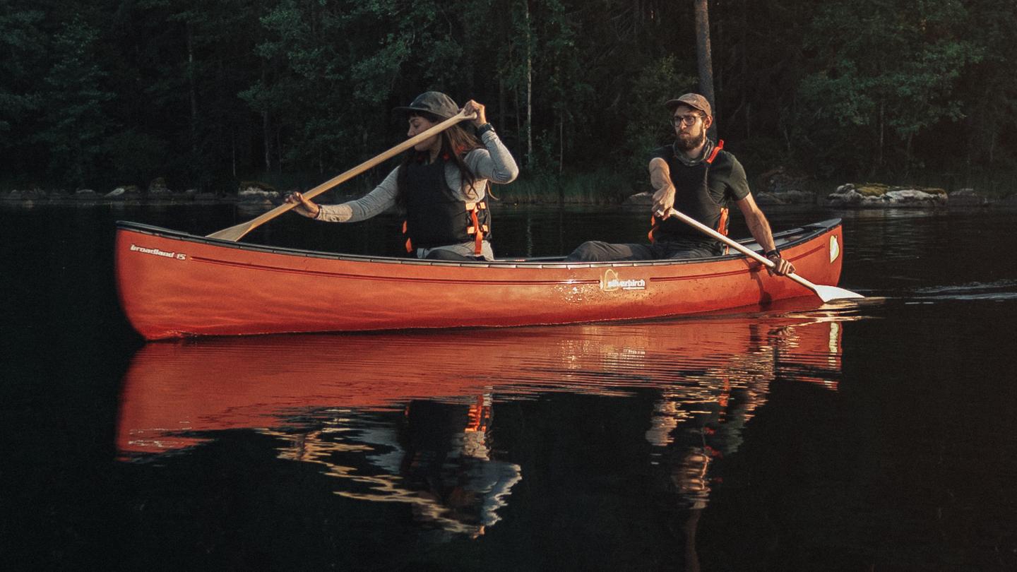 Two persons on a canoe.